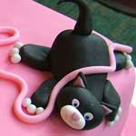 kitten playing with wool cake